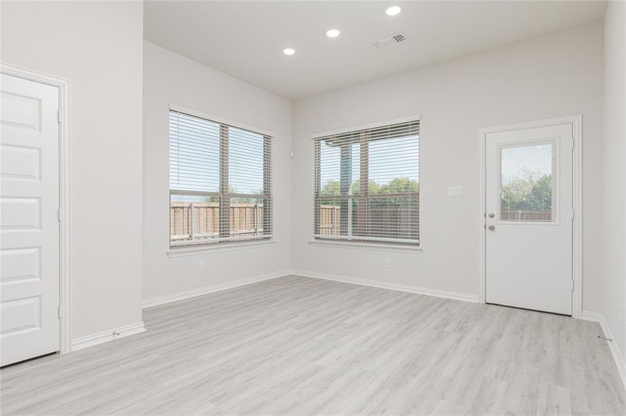 Empty room with light hardwood / wood-style flooring