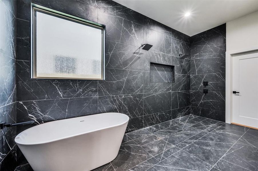 Bathroom featuring tile walls and independent shower and bath