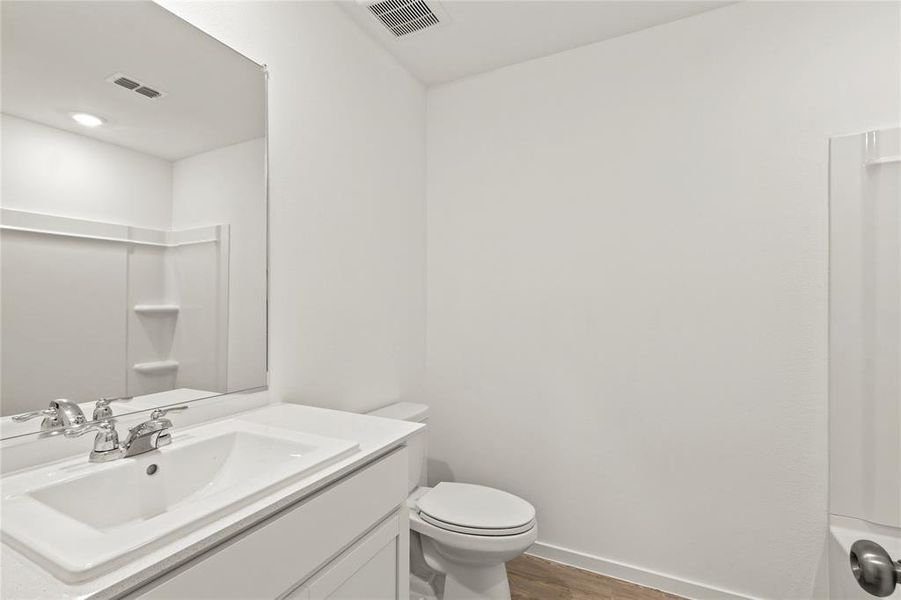 Modern bathroom vanity with integrated sink, chrome faucet, and expansive wall mirror