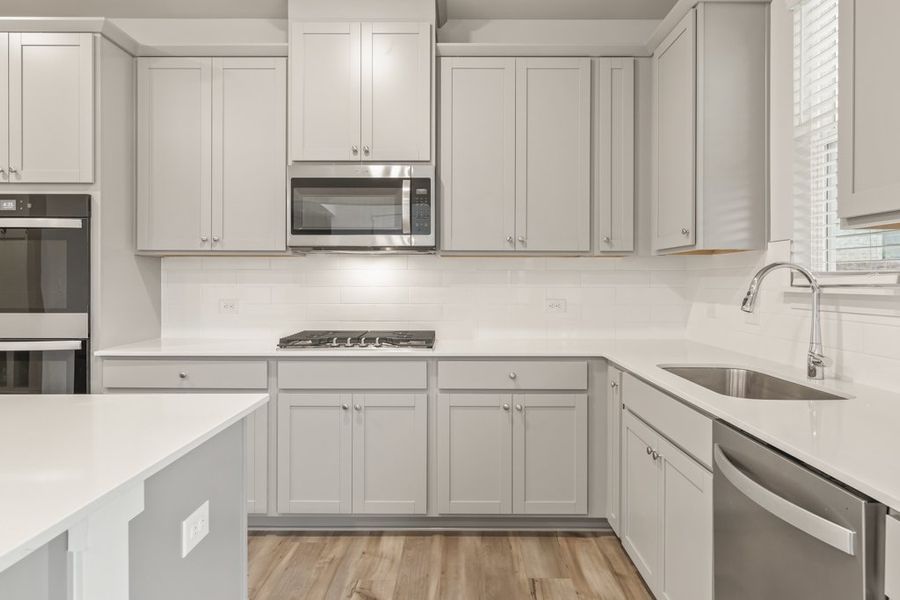 A kitchen with white cabinets. A kitchen with white cabinets.