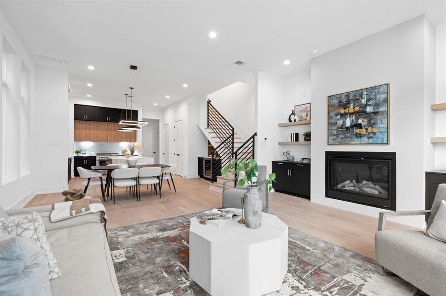 Spacious living area with fireplace that opens to the kitchen.