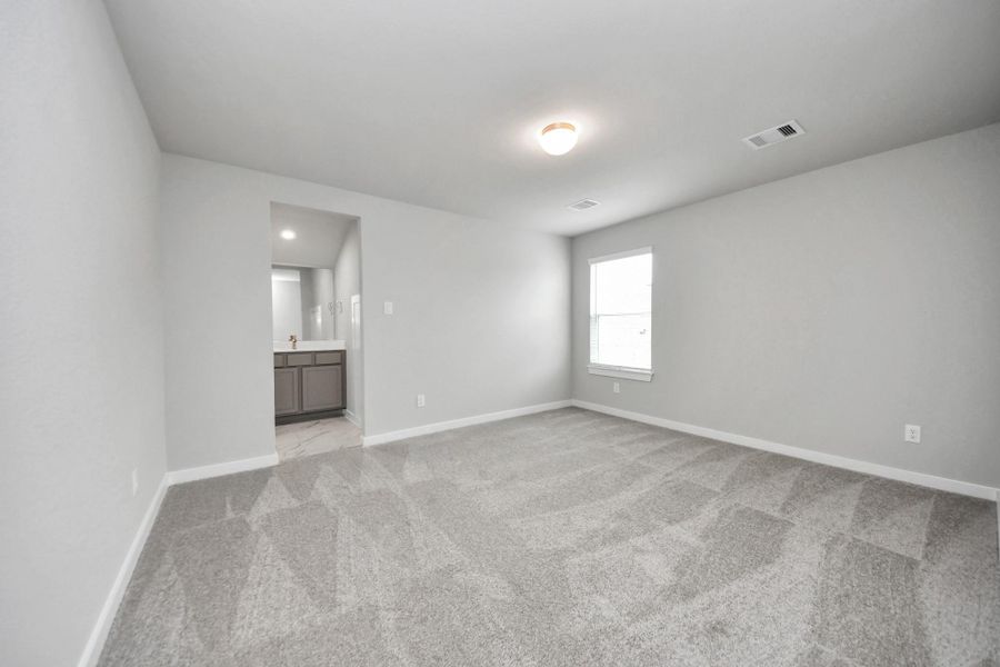 Secondary bedroom features plush carpet, custom paint, large window with privacy blindsand access to the Jack and Jill bath