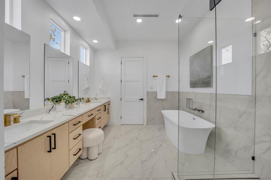 Bathroom with vanity, tile walls, and separate shower and tub