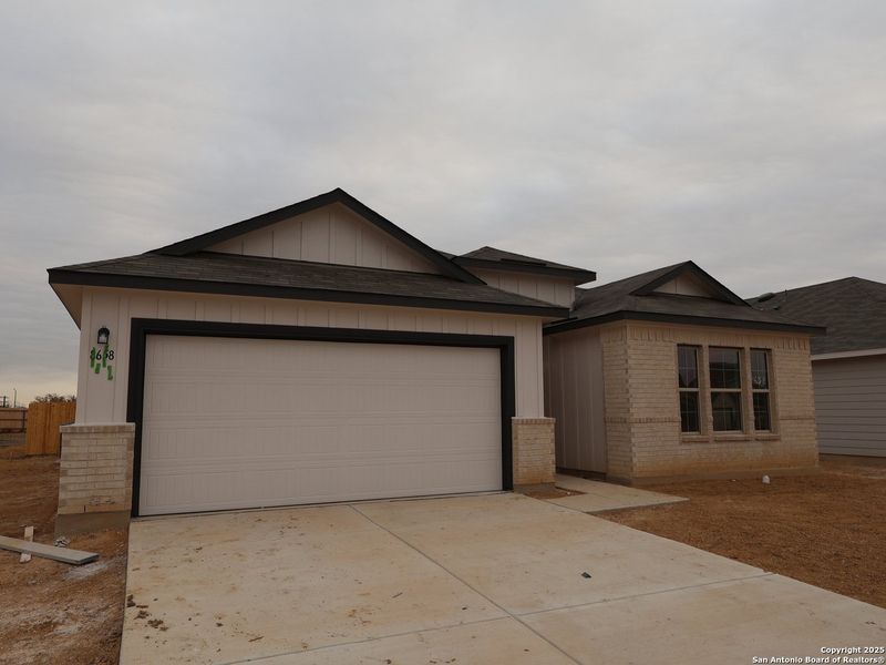Front exterior of a new home in Greenspoint Heights, Seguin, TX, highlighting curb appeal (Image 20).