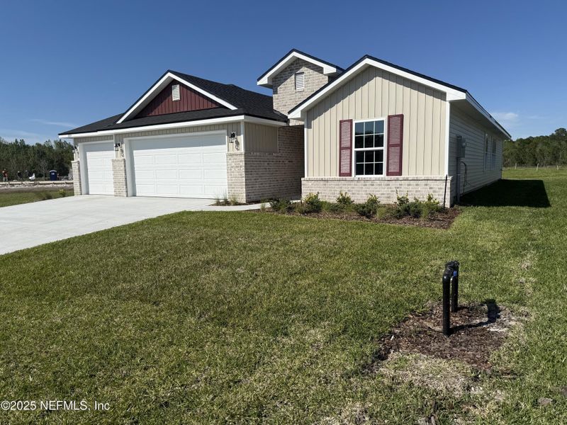 Front exterior of a new home in Summerglen, Jacksonville, FL, highlighting curb appeal (Image 2). Front exterior of a new home in Summerglen, Jacksonville, FL, highlighting curb appeal (Image 2).