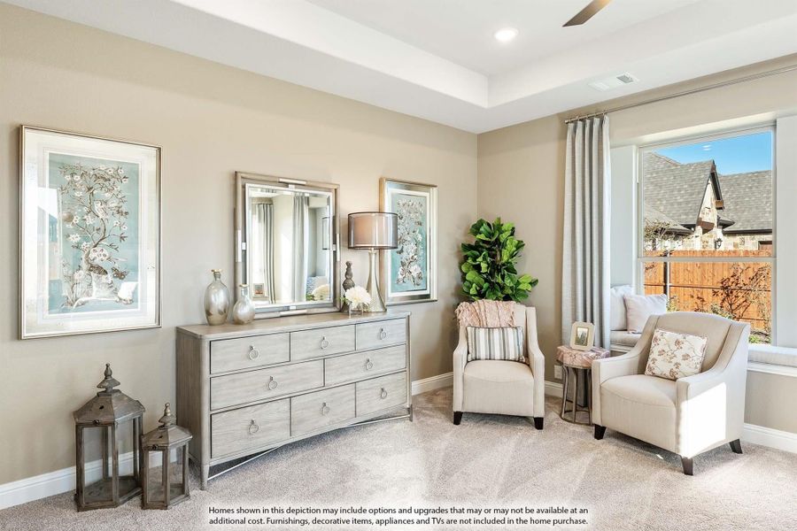 Bedroom sitting area with gray dresser, two accent chairs, and large window with natural light