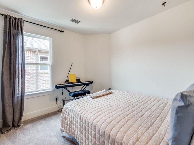Carpeted bedroom with baseboards