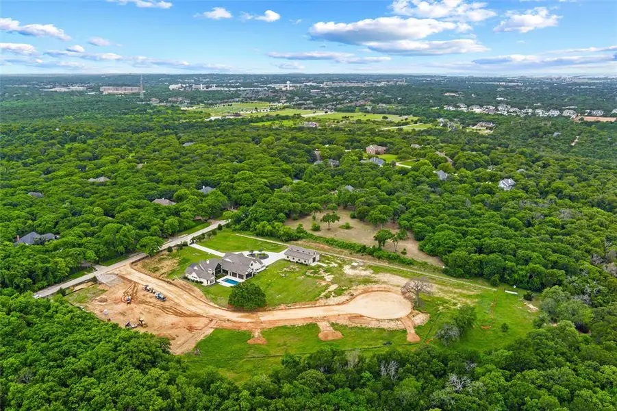 Expansive property featuring a contemporary home, detached auxiliary structure, private swimming pool, and a partially developed cul-de-sac Expansive property featuring a contemporary home, detached auxiliary structure, private swimming pool, and a partially developed cul-de-sac