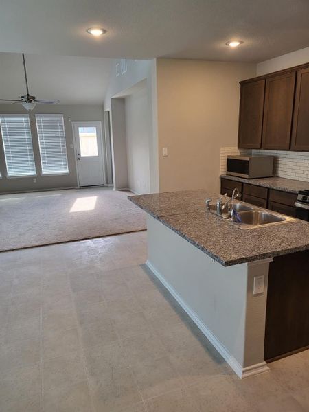 Kitchen opens to living area