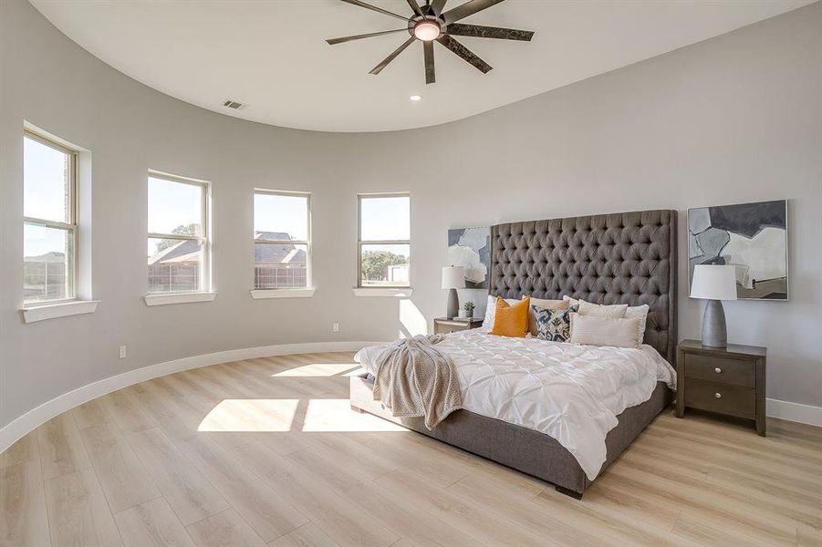 Bedroom featuring light wood-type flooring, ceiling fan, and recessed lighting