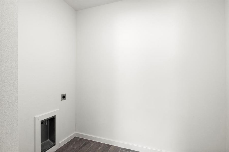 Laundry area with wood finish floors and electric dryer hookup