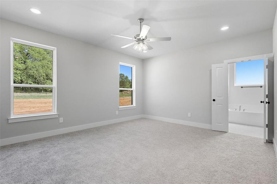 Spare room with light carpet, recessed lighting, plenty of natural light, and a ceiling fan Spare room with light carpet, recessed lighting, plenty of natural light, and a ceiling fan