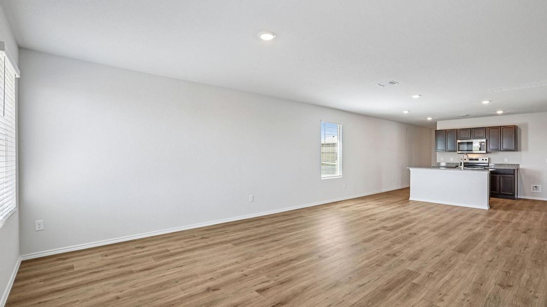 An open floorplan seamlessly connects the living space to a modern kitchen with a practical island.