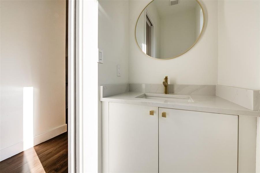 Bathroom featuring vanity and dark wood finished floors Bathroom featuring vanity and dark wood finished floors