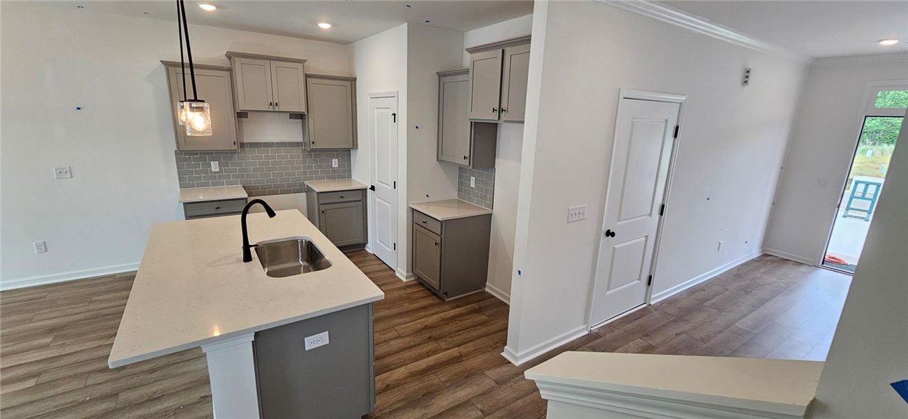 This modern kitchen features a spacious island, sl This modern kitchen features a spacious island, sl