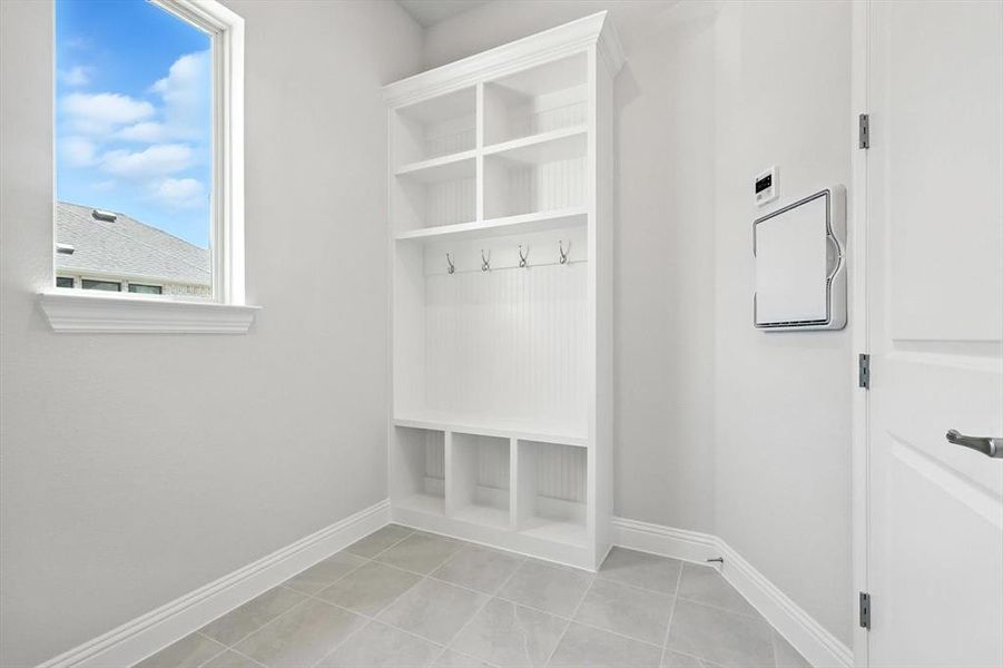 Mudroom with baseboards and light tile patterned floors Mudroom with baseboards and light tile patterned floors