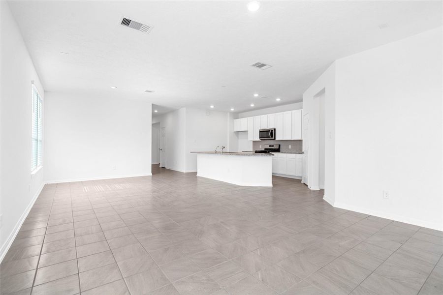 Stunning open-concept design seamlessly connecting the living, dining, and kitchen areas—perfect for both everyday living and entertaining!