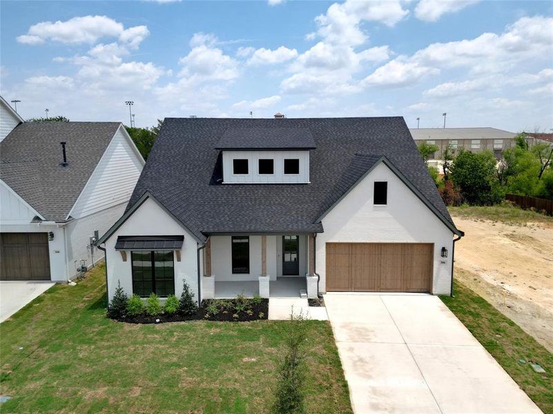 Modern farmhouse with a garage and a front yard