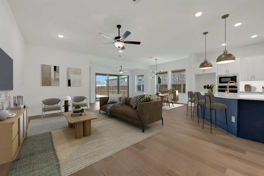 Living area with light wood finished floors, recessed lighting, and ceiling fan