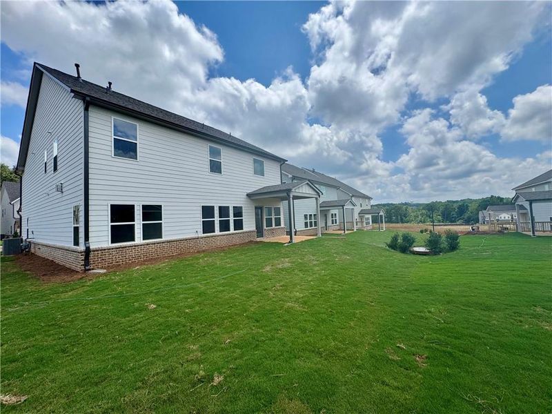 Front exterior of a new home in Eastlyn Crossing - Single Family, Flowery Branch, GA, highlighting curb appeal (Image 25). Front exterior of a new home in Eastlyn Crossing - Single Family, Flowery Branch, GA, highlighting curb appeal (Image 25).