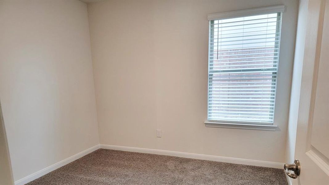 Carpeted spare room with healthy amount of natural light Carpeted spare room with healthy amount of natural light