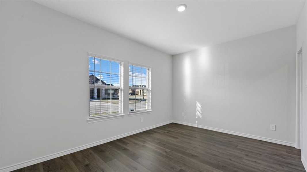 Spare room featuring dark wood finished floors and baseboards Spare room featuring dark wood finished floors and baseboards