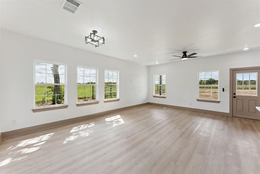 Unfurnished living room with light wood-style floors, recessed lighting, and ceiling fan Unfurnished living room with light wood-style floors, recessed lighting, and ceiling fan