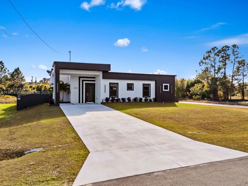Front exterior of a new home in , Lehigh Acres, FL, highlighting curb appeal (Image 22).
