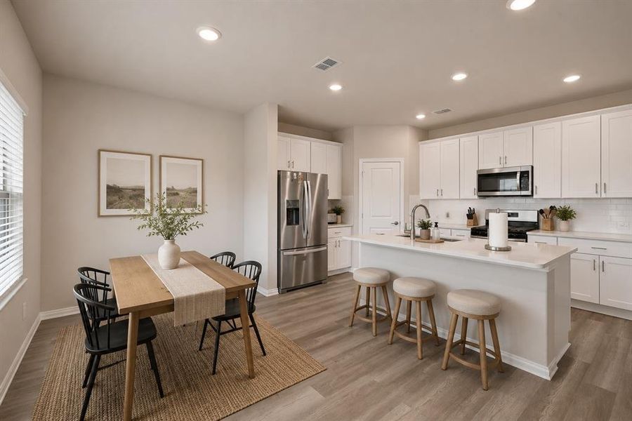 *Virtually Staged* 
Bright kitchen and dining area featuring light wood-finish flooring