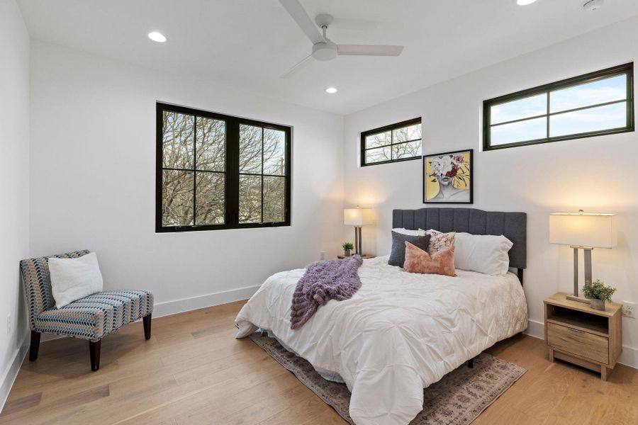 Bedroom with recessed lighting, light wood finished floors, baseboards, and ceiling fan