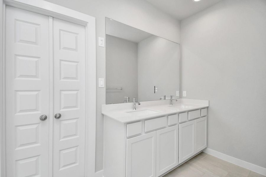 Escape to a spa-like oasis in this primary bathroom. Enjoy a walk-in shower with tile surround, a separate garden tub with custom detailing, and an elegant vanity featuring light countertops, modern hardware, and beautiful recessed lights. Experience luxury and relaxation in every detail. Sample photo of completed home with similar floor plan. Actual colors and selections may vary. Escape to a spa-like oasis in this primary bathroom. Enjoy a walk-in shower with tile surround, a separate garden tub with custom detailing, and an elegant vanity featuring light countertops, modern hardware, and beautiful recessed lights. Experience luxury and relaxation in every detail. Sample photo of completed home with similar floor plan. Actual colors and selections may vary.