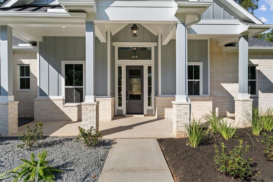 Covered Front Porch and Beautiful Landscaping!