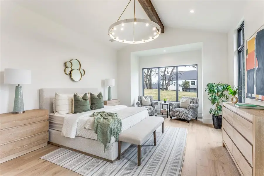 Oversized primary bedroom suite with living room and views of the amazing back yard.