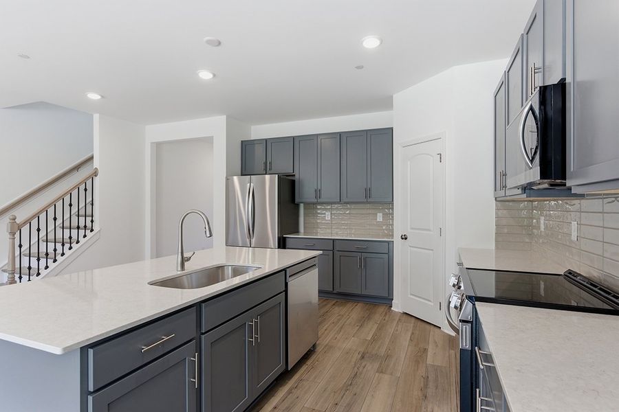 A kitchen with black cabinets. A kitchen with black cabinets.