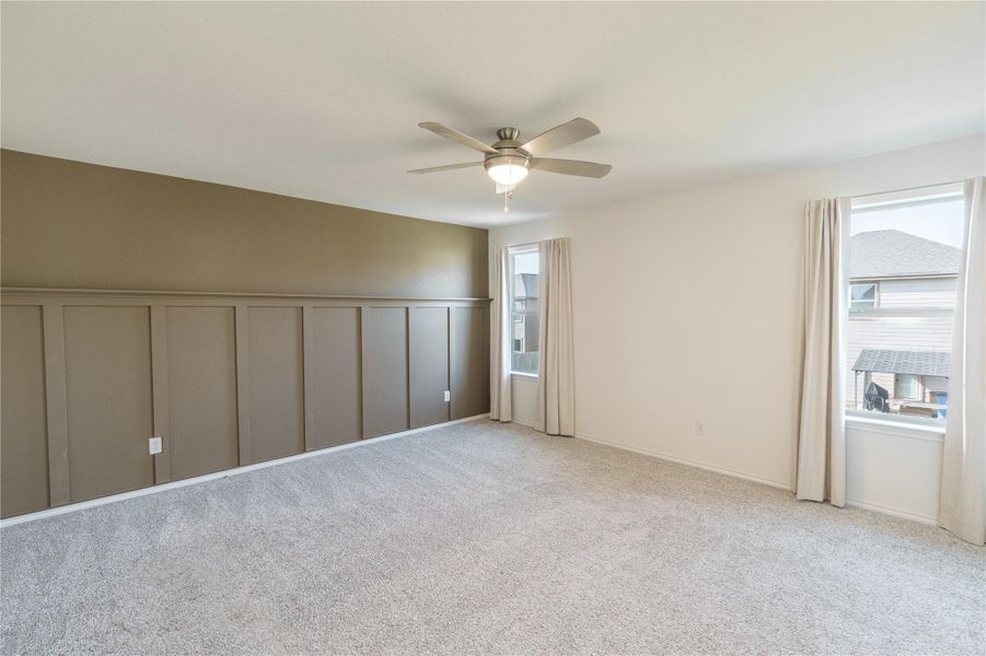 A quiet retreat with plush carpeting, natural light, and a modern ceiling fan for comfort. A quiet retreat with plush carpeting, natural light, and a modern ceiling fan for comfort.