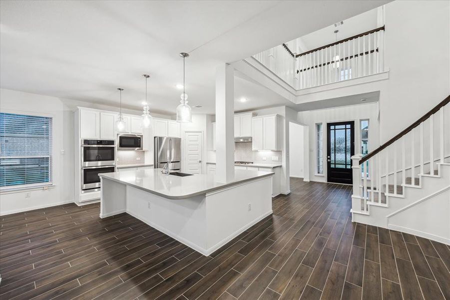 Welcome to the heart of the home! This expansive kitchen boasts double ovens, a sleek gas range, and top-of-the-line stainless steel appliances. With ample counter space and a functional layout, it’s perfect for culinary adventures and entertaining family and friends.