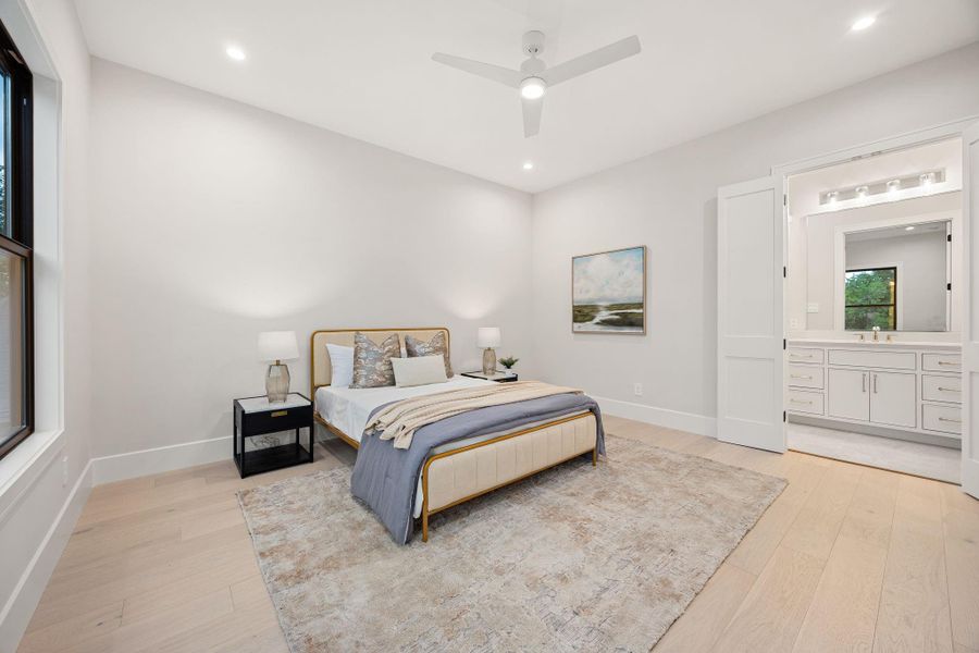 A bright and inviting bedroom offering a peaceful retreat, complete with soft finishes and generous space. Natural light enhances the warm tones throughout, creating a relaxing atmosphere. The highlight of this room is the direct connection to a spacious ensuite bathroom, providing added privacy and convenience while elevating the overall comfort of the suite.