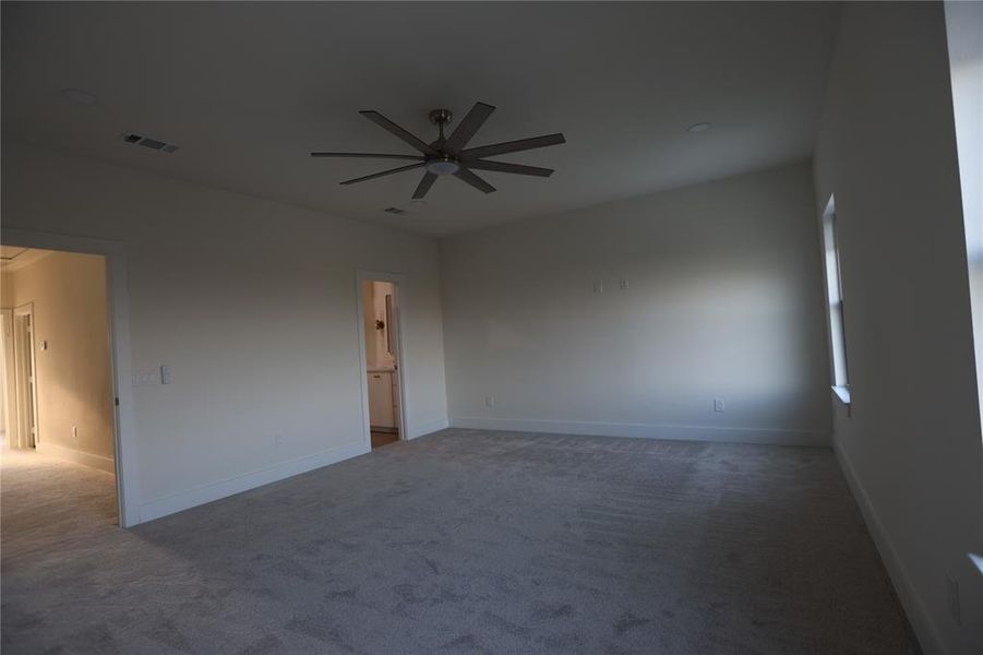 Unfurnished room with carpet flooring and a ceiling fan Unfurnished room with carpet flooring and a ceiling fan