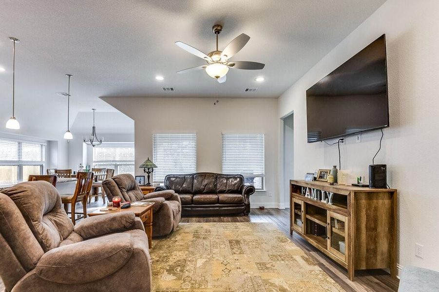 The living room is spacious, featuring high ceilings and an abundance of natural light.