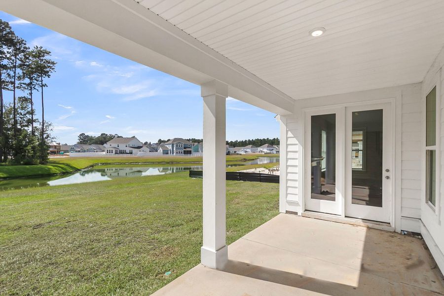 Exterior details and patio area of a home in Tidewater at Lakes of Cane Bay, Summerville (Image 4).