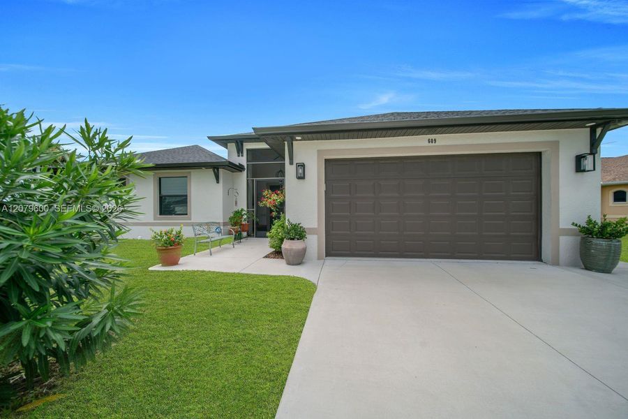 Front exterior of a new home in , Lehigh Acres, FL, highlighting curb appeal (Image 25). Front exterior of a new home in , Lehigh Acres, FL, highlighting curb appeal (Image 25).
