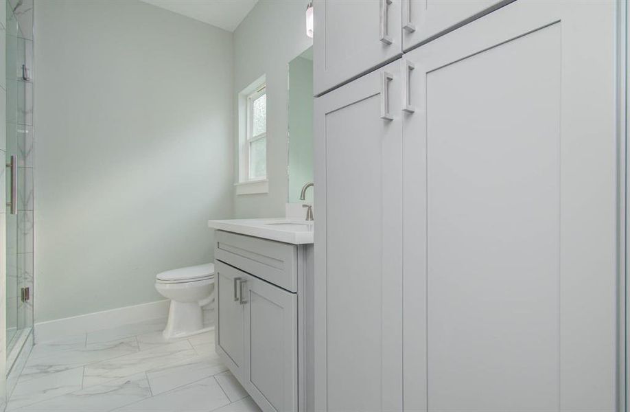 This bathroom featuring custom built cabinets