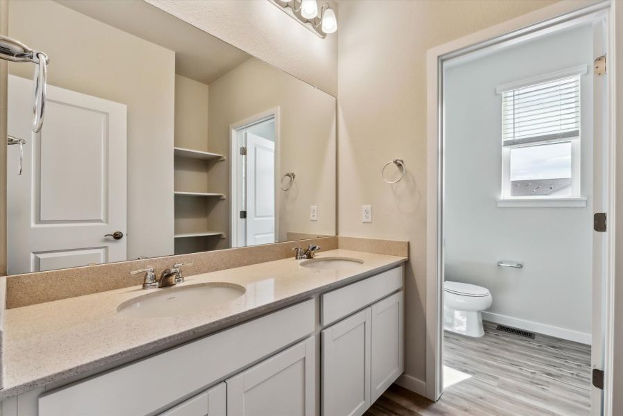 A bathroom with a large mirror.
