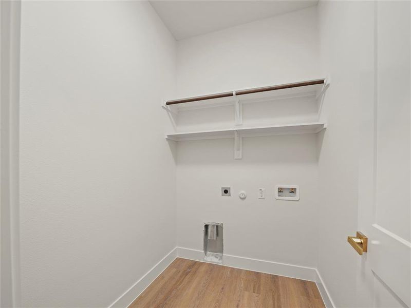Laundry room with gas dryer hookup, light wood-style floors, electric dryer hookup, and hookup for a washing machine