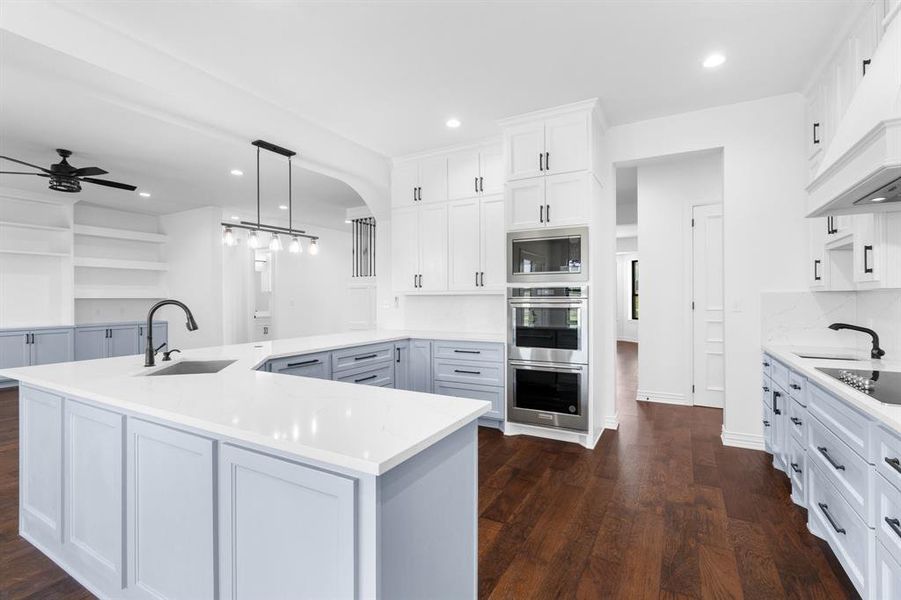Kitchen featuring premium range hood, stainless steel appliances, a ceiling fan, dark wood-style floors, and recessed lighting Kitchen featuring premium range hood, stainless steel appliances, a ceiling fan, dark wood-style floors, and recessed lighting