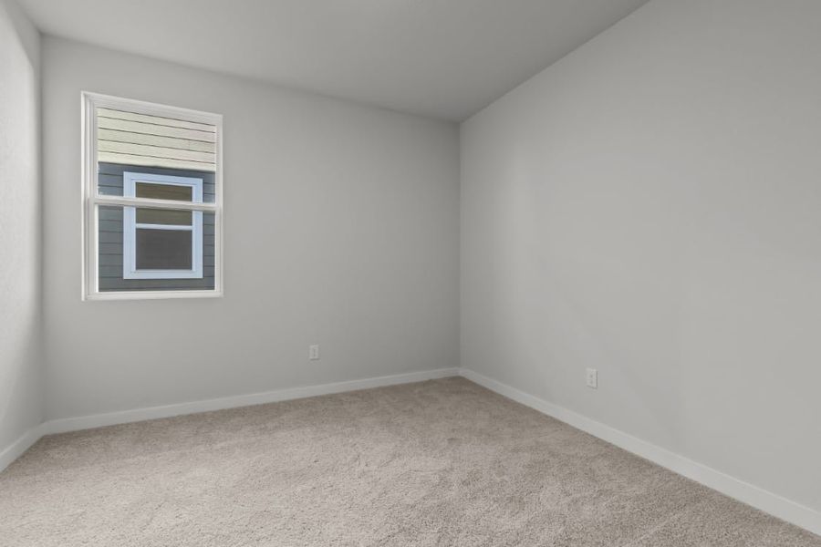 A room with a window and a carpet.