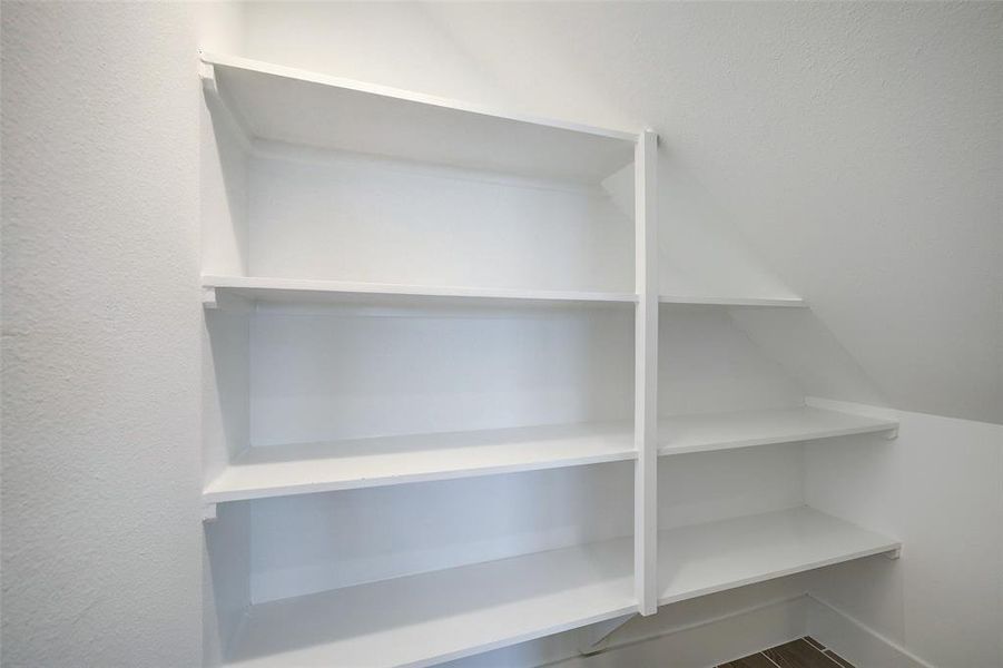 Making used of every bit of space, a sizable walk-in pantry is placed beneath the stairs.