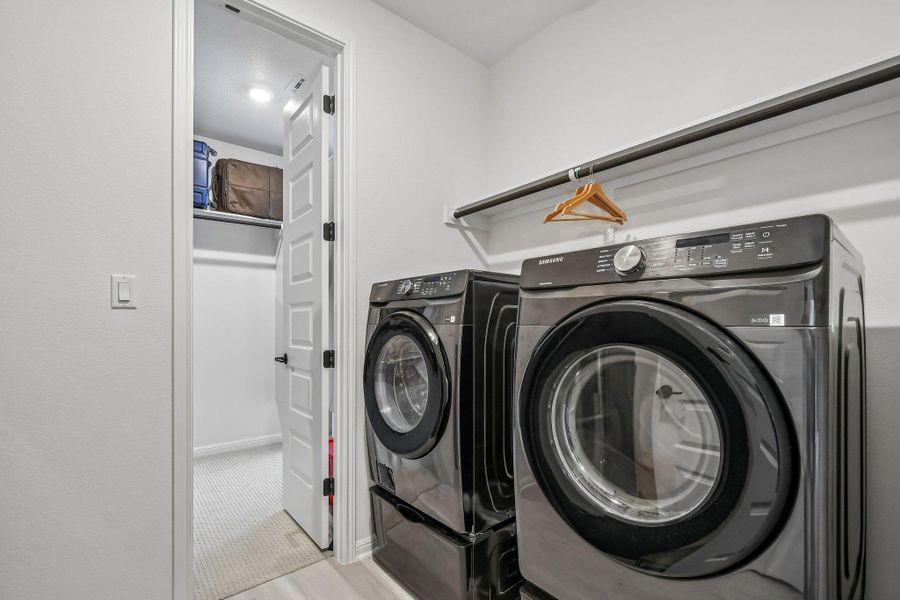A well-appointed laundry area, complete with modern appliances, offers efficient household management.