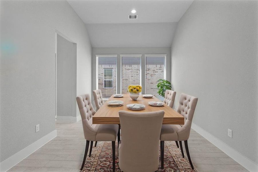 Make memories gathered around the table with your family and friends! This dining room features high ceilings, recessed lighting, large windows with privacy blinds, and beautiful tile flooring!