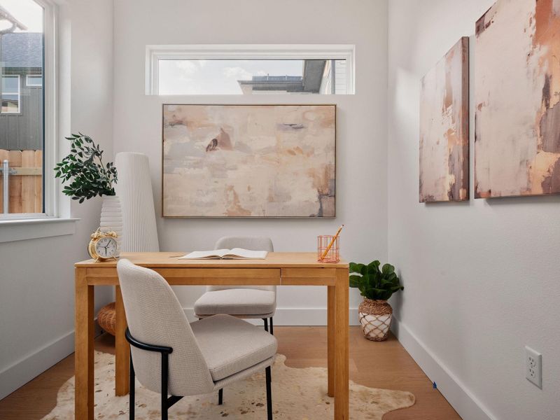 Office area featuring light wood-style floors and baseboards